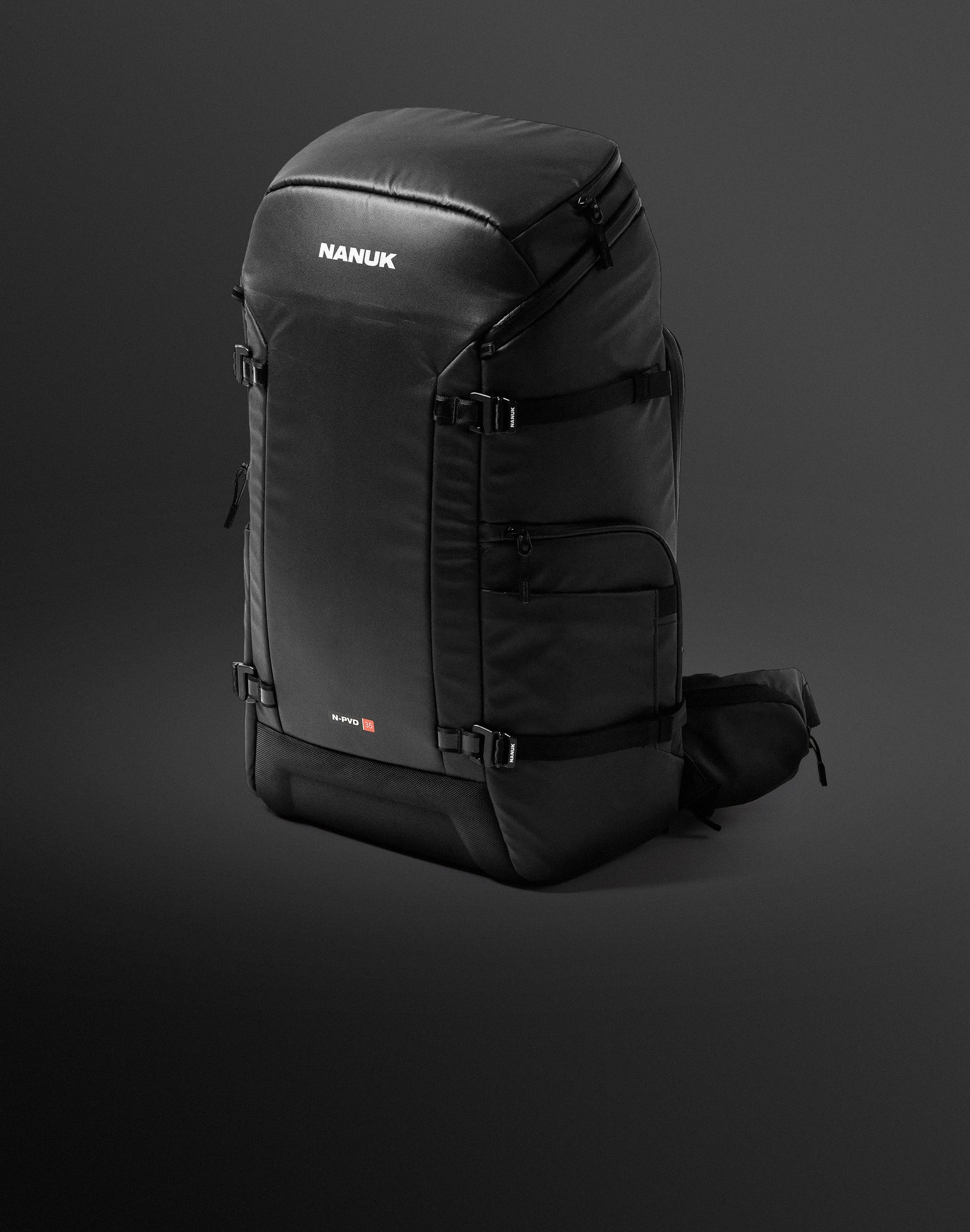 A black Nanuk N-PVD 35 backpack, reflecting the durable design of nanuk cases, stands prominently on a dark, gradient background.