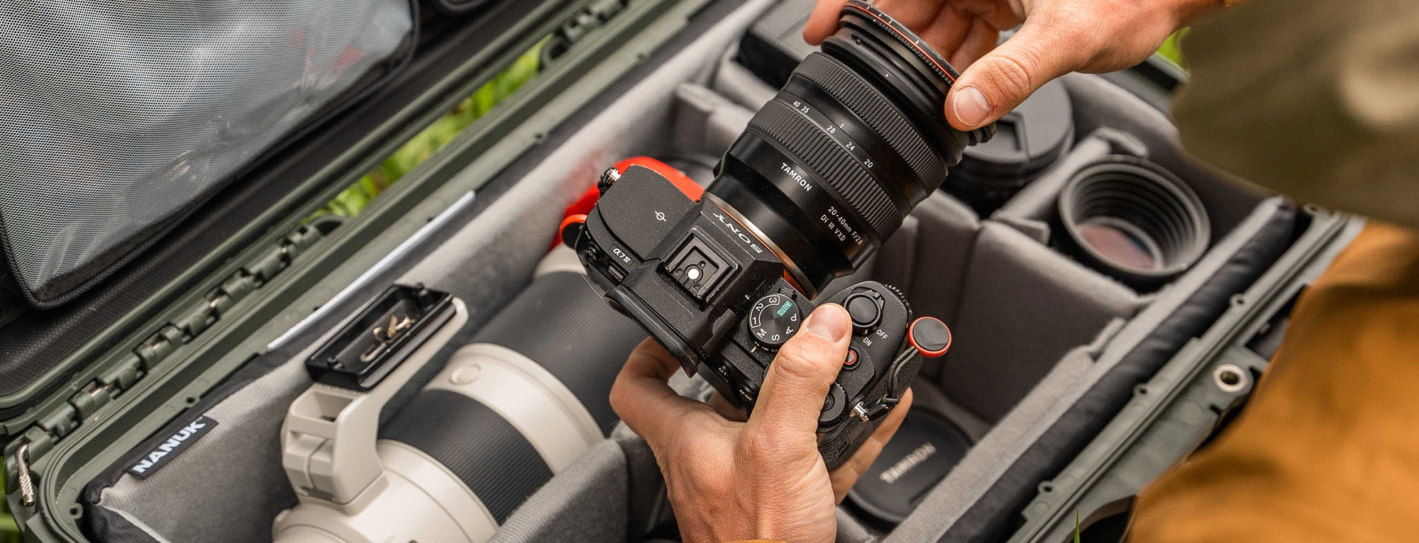 Camera being adjusted inside a camera bag with a blurred background