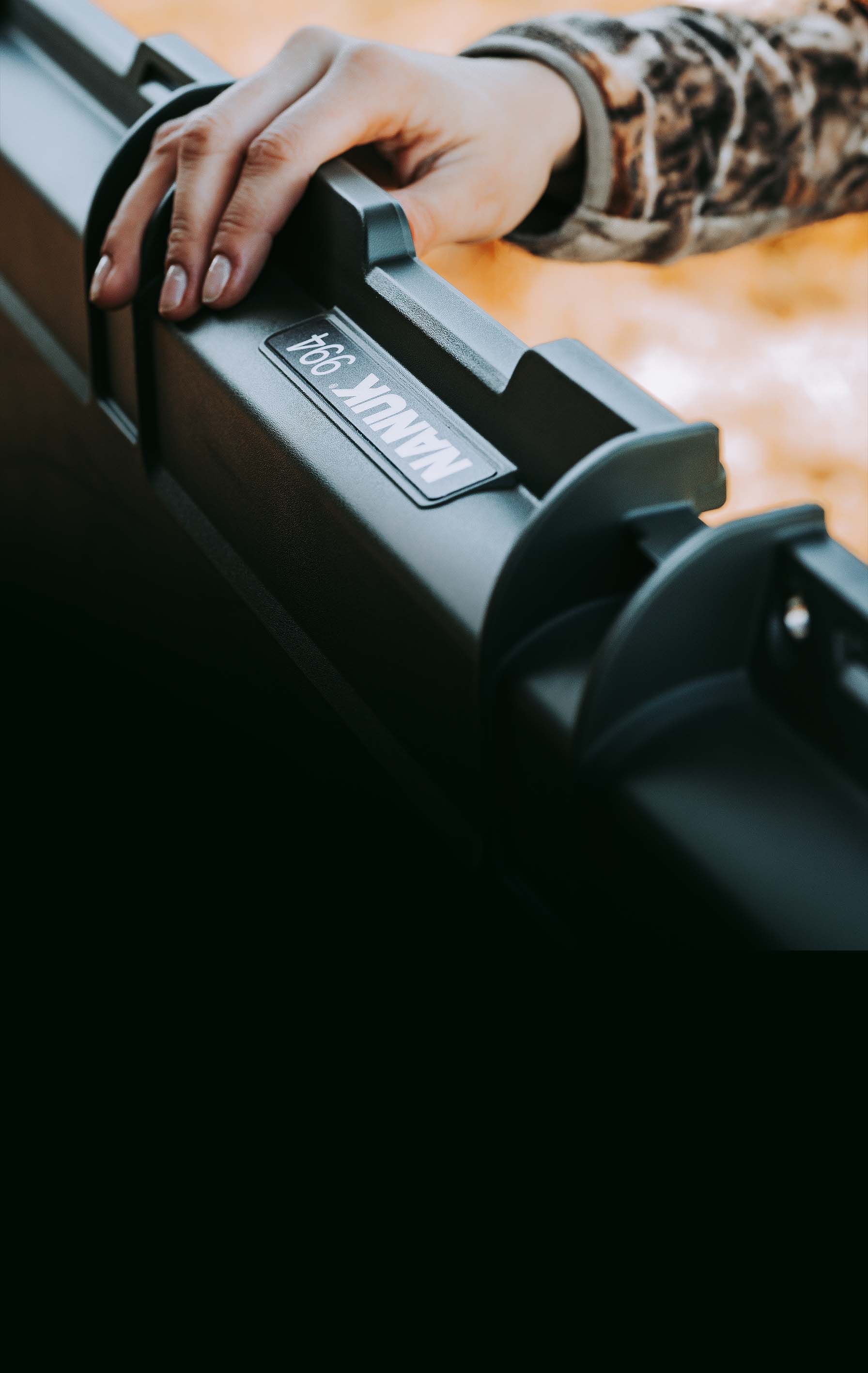 Hand holding a black rifle with 'Tobin & Wesson' branding.