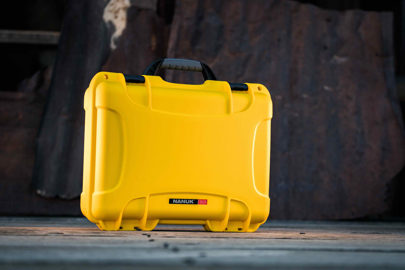 Front view of a durable yellow NANUK 910 case with a black handle, ideal for safeguarding sensitive equipment.