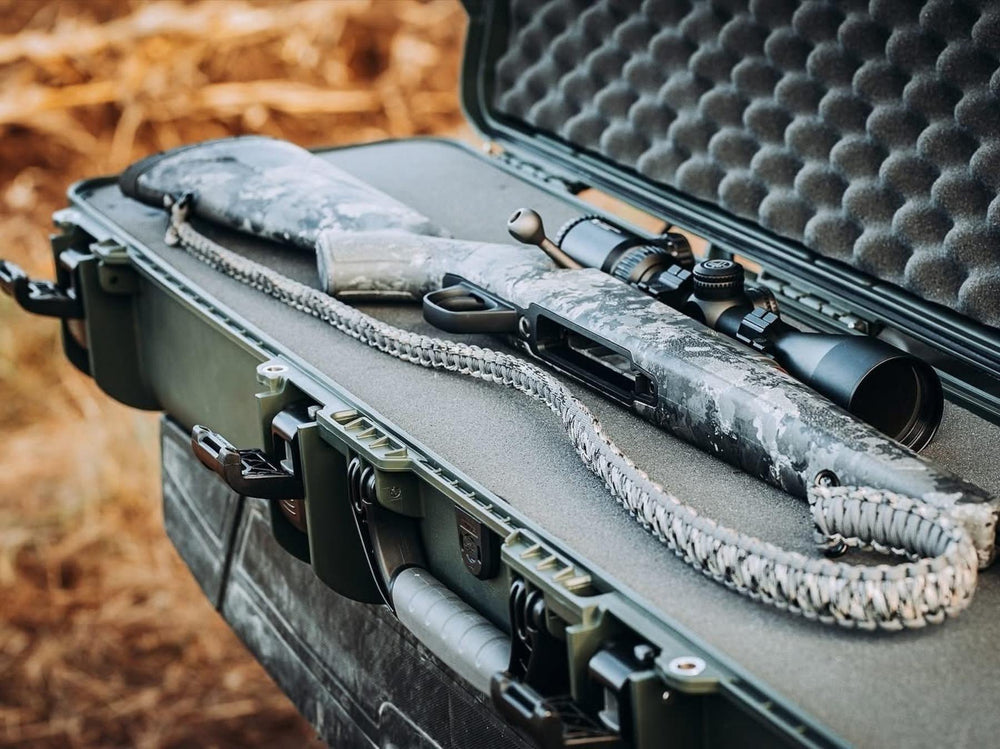 Rifles with scope in a protective case on a natural background