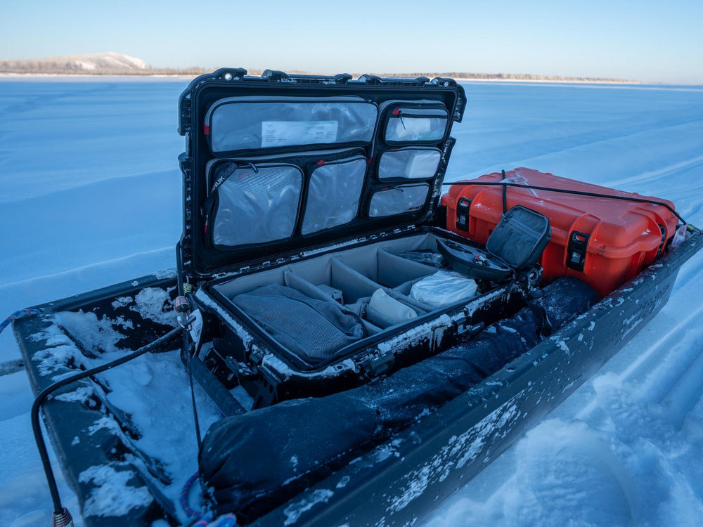 Ice fishing boat with open storage compartment on a frozen lake