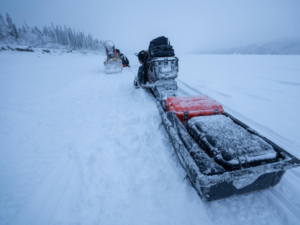 Snowmobile with equipment on a snowy landscape