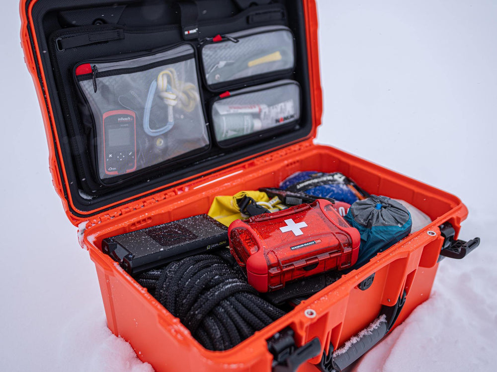 Orange waterproof case with medical supplies on a white background