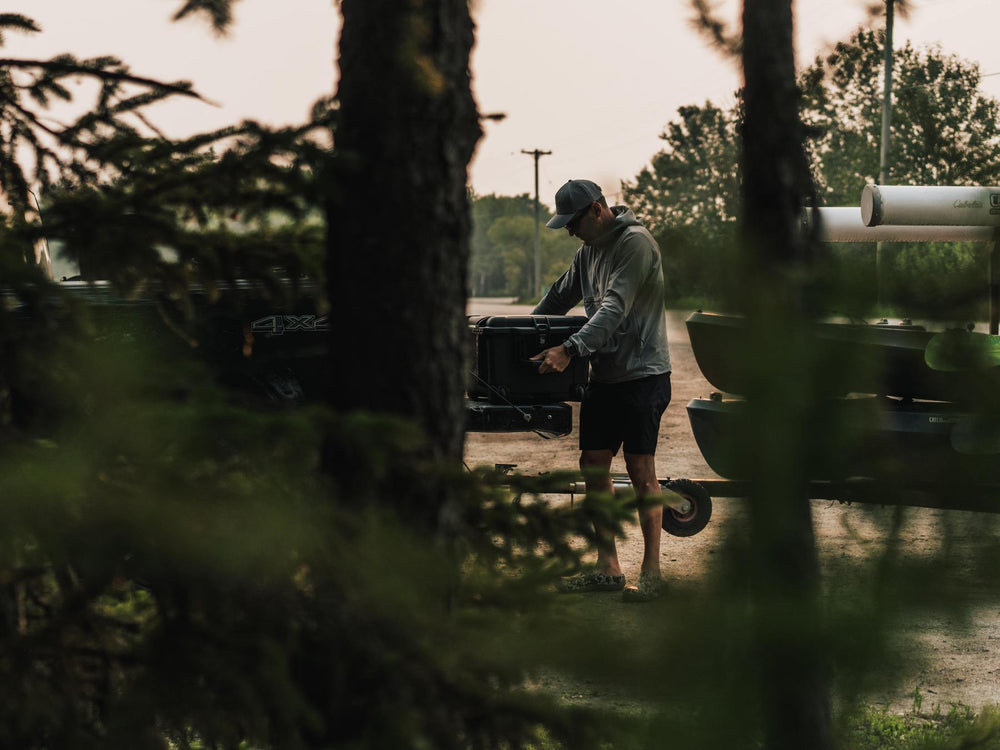 Man unloading a truck in a wooded area