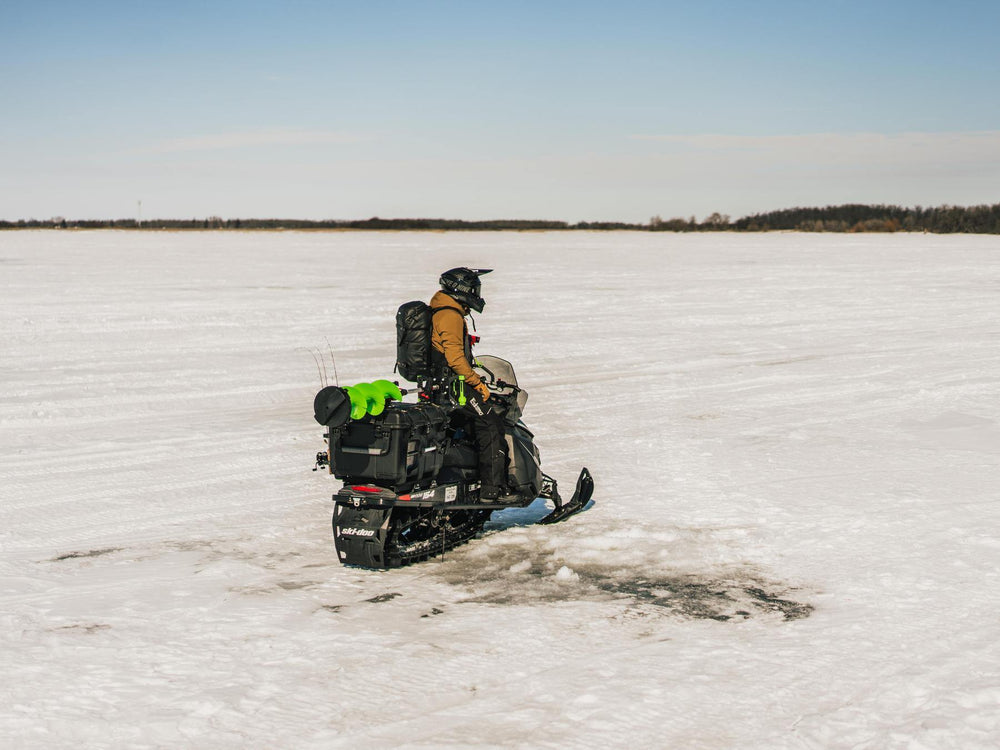 Person on a snowmobile in a snowy landscape