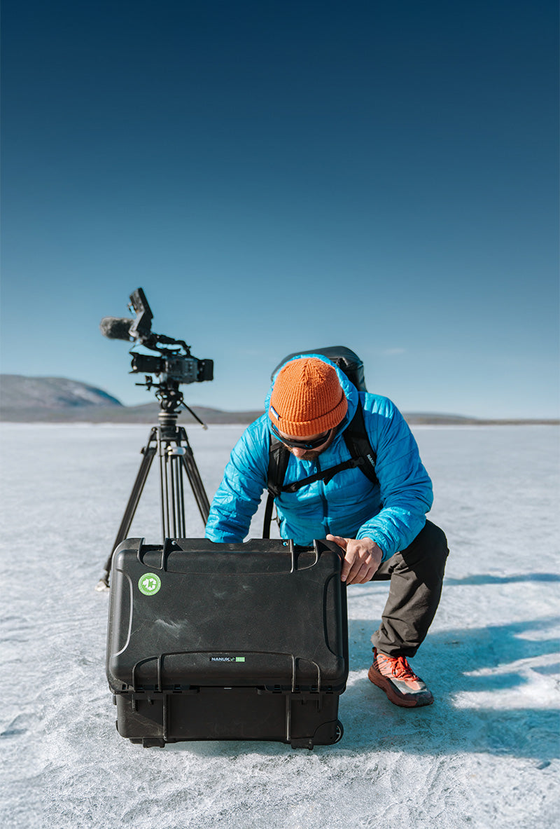 Professional Videographer looking into his NANUK 935 Hard Case in a cold environment