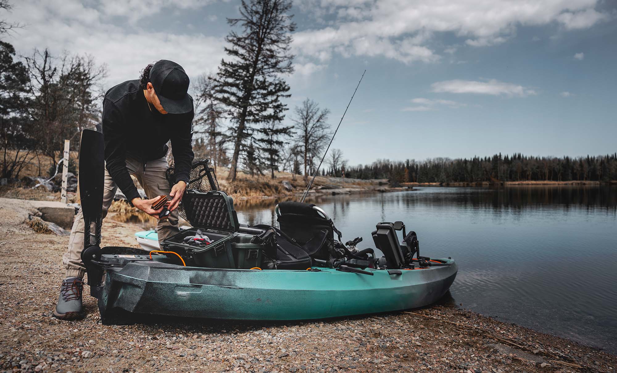 Men setting up his gear in NANUK Cases on a small fishing boat
